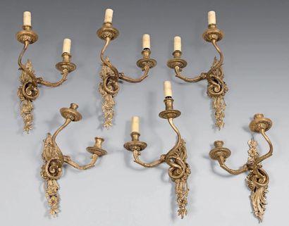 null Suite of three pairs of asymmetrical two-light sconces in gilt bronze with foliage.
Louis...