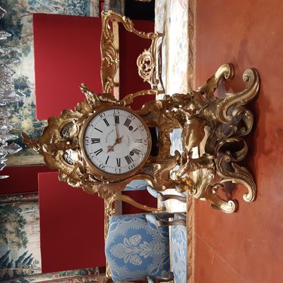 null Large rocaille clock on its base, in gilded bronze decorated with characters...