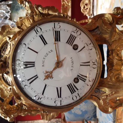 null Large rocaille clock on its base, in gilded bronze decorated with characters...