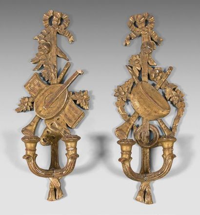 null Pair of gilded wood sconces with two lights carved with music trophies and ribbons.
Louis...