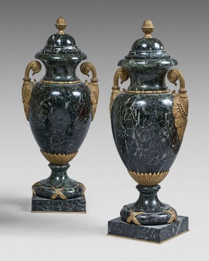 null Pair of ovoid sea green marble covered urns with two leafy handles in gilt bronze....