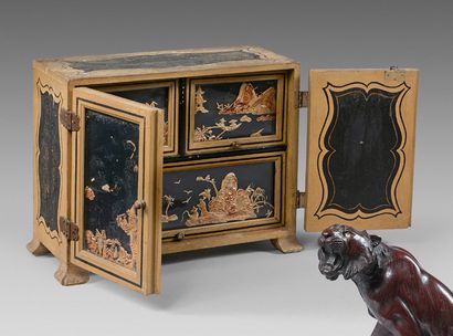 null Small cabinet opening with two leaves discovering three drawers decorated with...