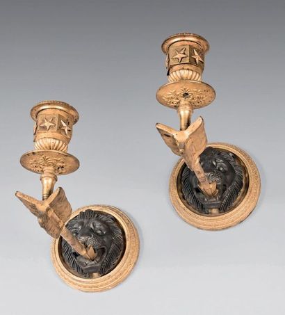 null Pair of ormolu and patinated bronze sconces decorated with a lion's whelp biting...