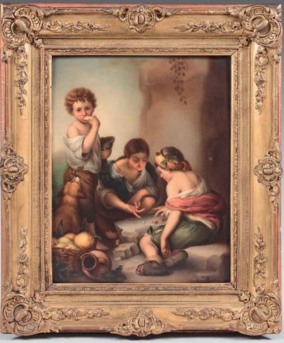 null Polychrome porcelain plate with children playing dice in a gilded frame.
19th...
