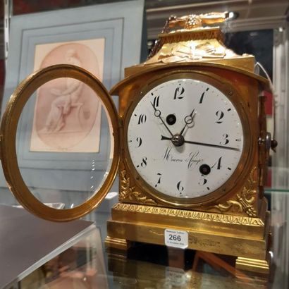  Gilt bronze table clock decorated with music trophies. Enamel dial signed Meuron...