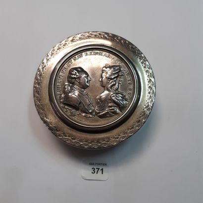 null A round silver box partially decorated with interlacing, the lid with a medal...