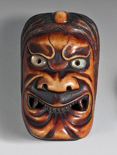 JAPON - Epoque MEIJI (1868-1912) 
Netsuke en os, deux masques accolés, les yeux incrustés...