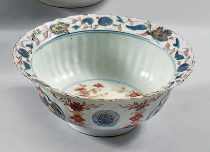 null Porcelain bowl with a flared edge and its lobed display stand decorated in blue...
