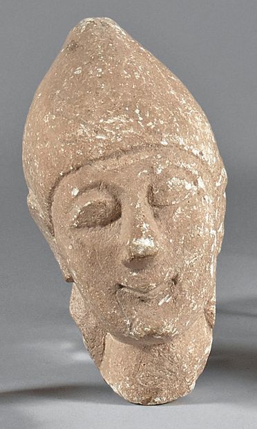 null 
Male head wearing a pointed cap from a votive statuette. Beige limestone.



Cyprus,...