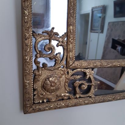 null Rectangular mirror in a double frame with spandrels and pediment in gilded wood...