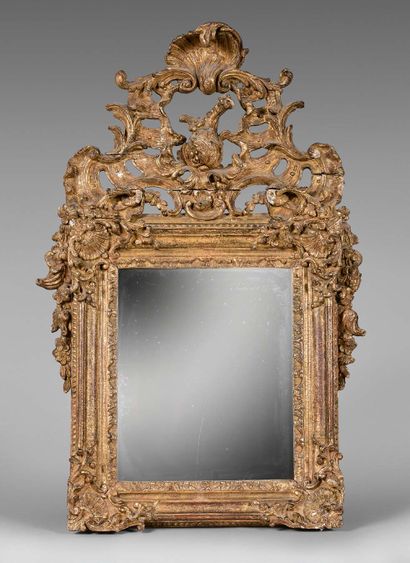 Mirror in a gilded wood frame with an openwork...