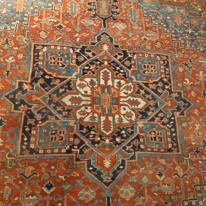 null Heriz carpet decorated with a star medallion and spandrels on a background decorated...