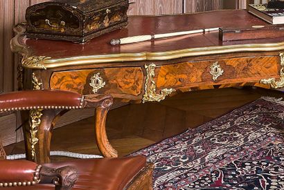  A flat desk with an ormolu top with ormolu corner pieces and astragals. Inlaid belt...