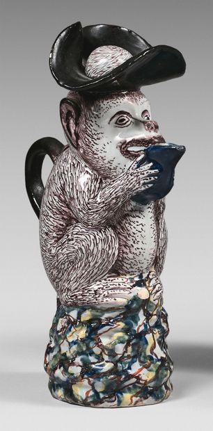 DELFT Pitcher in the form of a monkey sitting on a base with abstract motifs, holding...