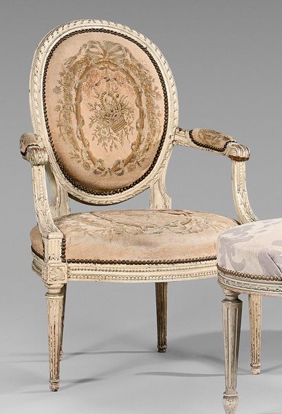 null Armchair with a cabriolet medallion back in white lacquered beech wood carved...