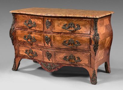 null A rosewood and rosewood veneered chest of drawers with a curved front, opening...