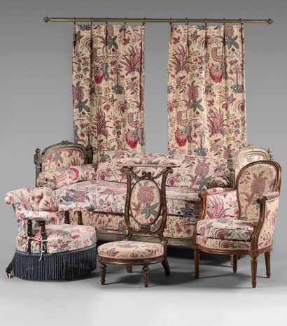 null Furniture covered with a flowered fabric including: a low armchair with turned...