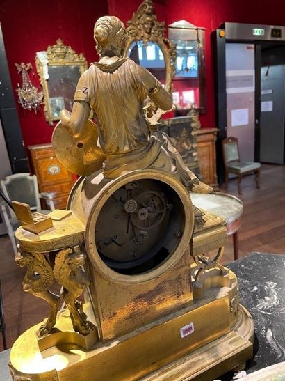 null 
Gilt bronze clock decorated with a young woman entrusting a missive to a carrier...