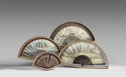 null Two fans, one with mother-of-pearl strands inlaid with golden motifs, the leaf...