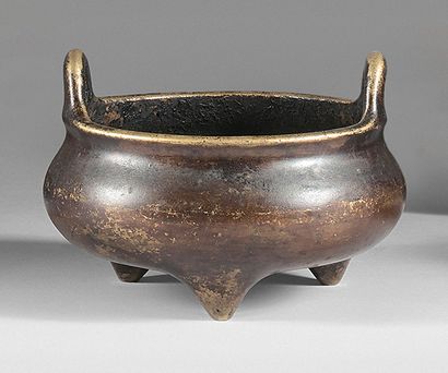 CHINE - XVIIe siècle Brûle-parfum tripode en bronze à patine brune et traces de dorure....