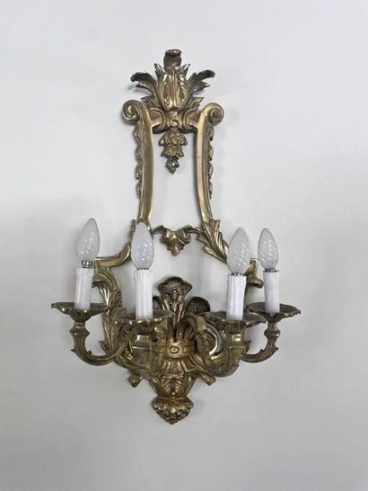 null Suite of four large gilt bronze sconces with five arms of light. Shaft in stylized...