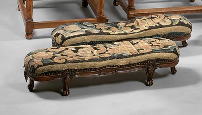 null Pair of small rectangular beechwood footstools with six scrolled feet.
Louis...