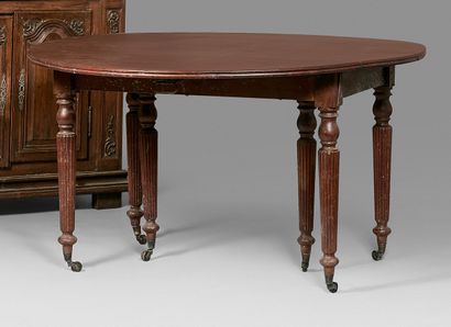 null Large oval mahogany dining table with shutters and extensions. Six tapered legs...