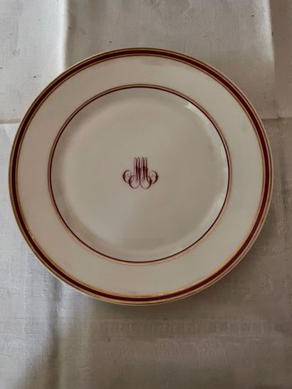 null Thirty-five white porcelain plates with burgundy and gold nets, monogrammed...