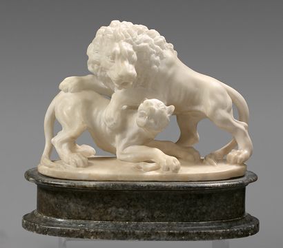 null Alabaster statuette carved with a lion and a lioness fighting over a bone. Painted...