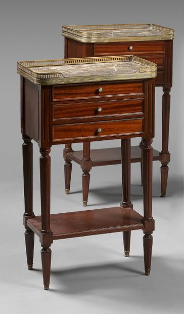 null Pair of small mahogany bedside tables, opening with three drawers. Marble top...