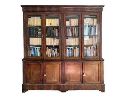 null Mahogany and flamed mahogany veneer bookcase, opening with four glass doors...