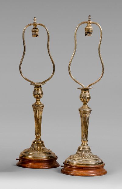 null Pair of brass torches formerly silvered. Fluted shaft, round beaded base.
Late...