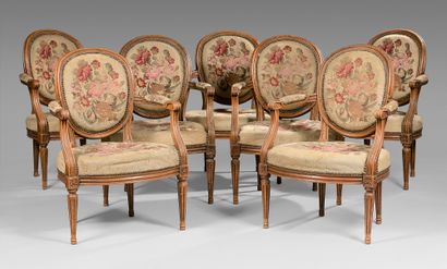 null Suite of seven cabriolet medallion back armchairs in moulded beech. Armrests...