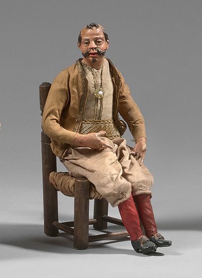 null Turkish character in polychrome terracotta, sitting on a straw chair.
Height...