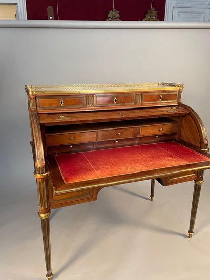 null Large mahogany cylinder desk with brass filleting, opening with three drawers...