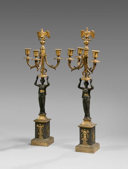 null A pair of ormolu and patinated bronze candelabras decorated with a draped caryatid...