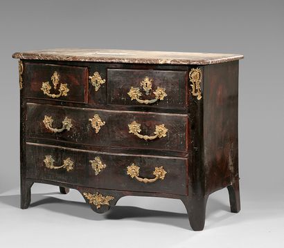 null A rosewood veneered chest of drawers with a curved front, opening to four drawers...