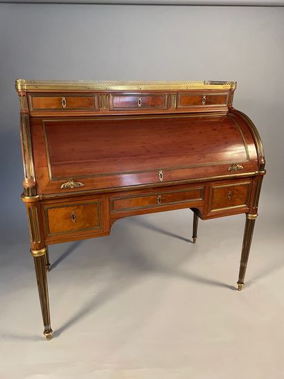 null Large mahogany cylinder desk with brass filleting, opening with three drawers...