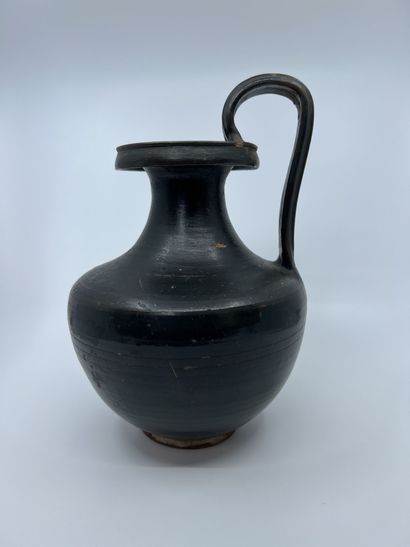 null OENOCHOE with fluted ribbon handle and shouldered belly. Black glazed beige...