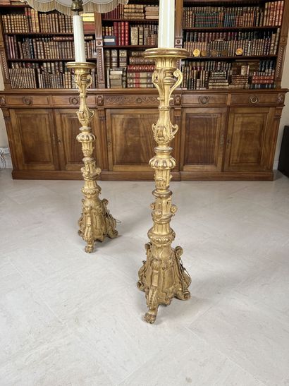 null Pair of large giltwood candlesticks carved with crosses and foliage, on a tripod...