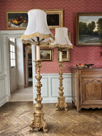 null Pair of large giltwood candlesticks carved with crosses and foliage, on a tripod...