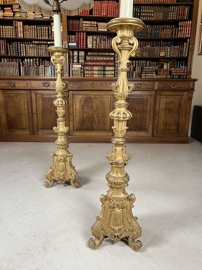 null Pair of large giltwood candlesticks carved with crosses and foliage, on a tripod...