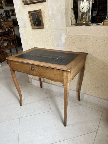 null Walnut table opening to a drawer. 
Top covered with leather (damaged), cambered...