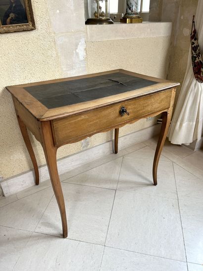null Walnut table opening to a drawer. 
Top covered with leather (damaged), cambered...