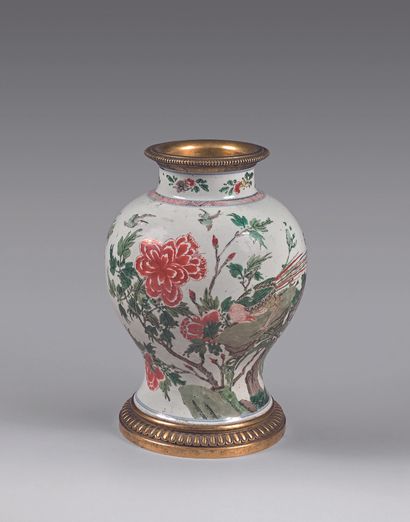 null CHINA
Porcelain jar with polychrome decoration on a background of shrubs of...