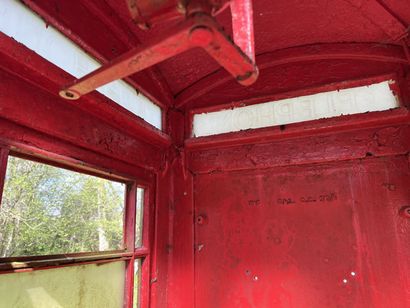 null TELEPHONE CABINET in red lacquered sheet metal decorated with crowns in relief,...