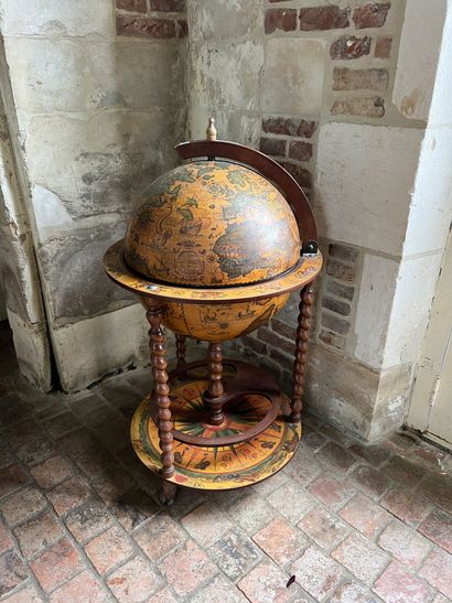 null GLOBE TERRESTRIAL forming a secret bar in turned and carved wood, covered with...