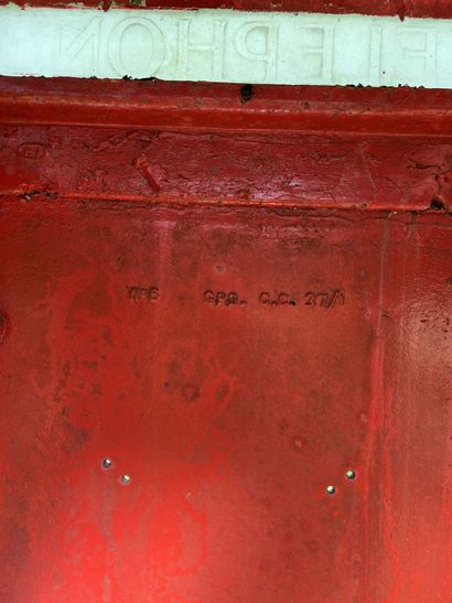 null TELEPHONE CABINET in red lacquered sheet metal decorated with crowns in relief,...