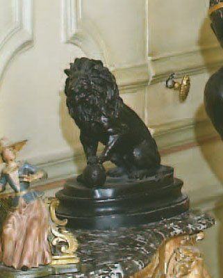 STATUETTE de lion assis en métal laqué noir....