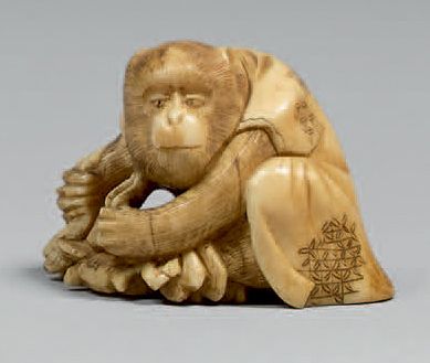 JAPON - Epoque MEIJI (1868-1912) Netsuke en ivoire, singe en habit tenant un crabe...